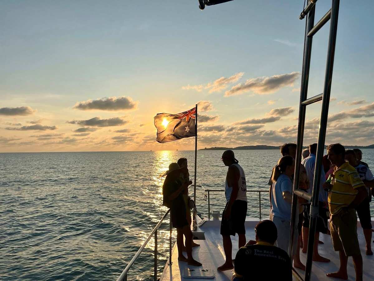As the sun rises on Anzac Day in Maenam on the Beat Boat