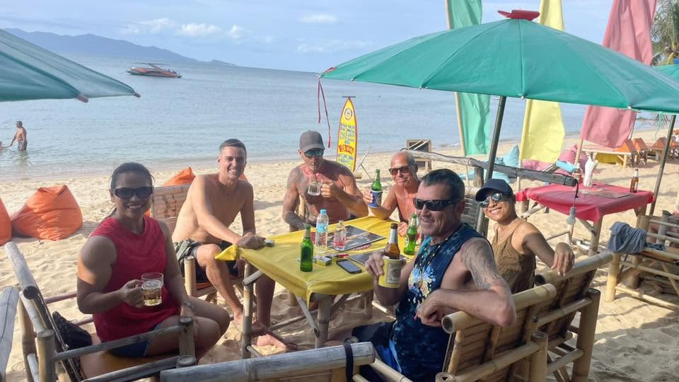 Beach Party guests seated together beside the beach