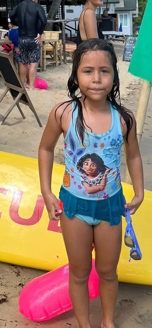 Young Surf Club swimmer beside the yellow rescue board