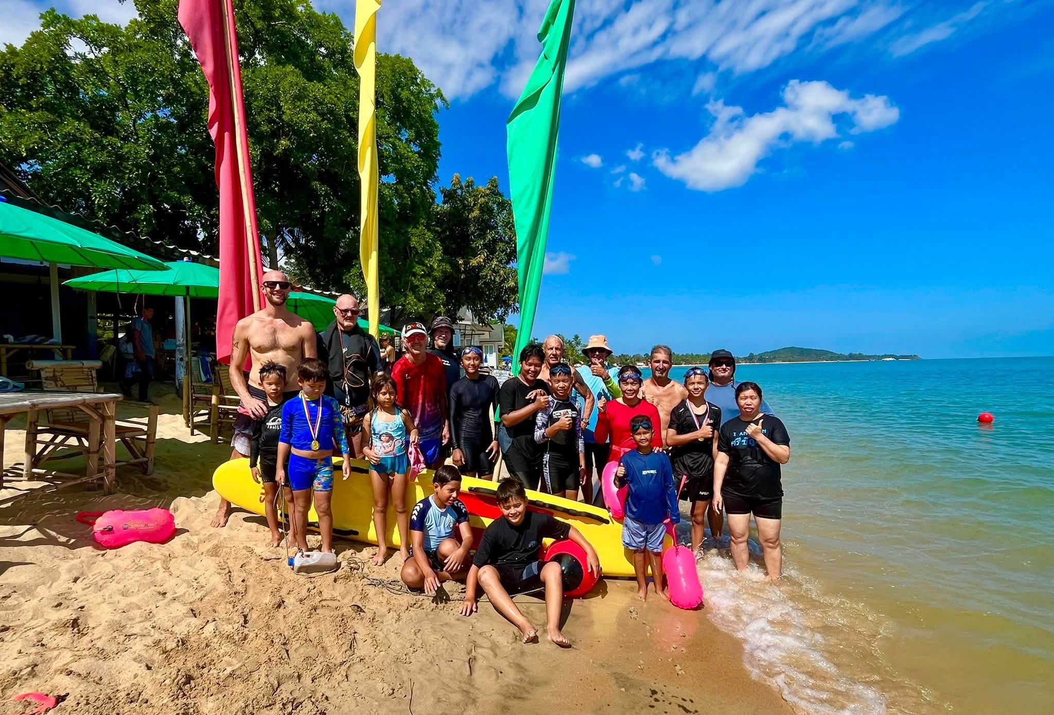 Children and volunteers at a Sunday beach session