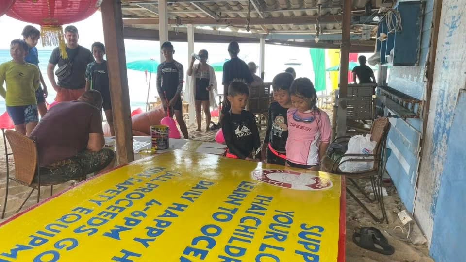Tony teaching children how to paint